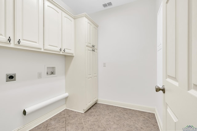 washroom featuring hookup for a washing machine, electric dryer hookup, visible vents, baseboards, and cabinet space
