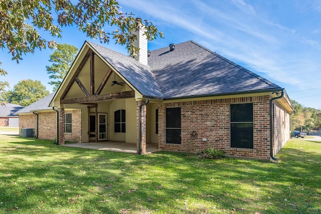 rear view of house featuring a patio area, a yard, and cooling unit