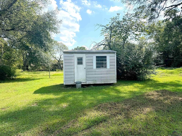 view of outbuilding with a lawn