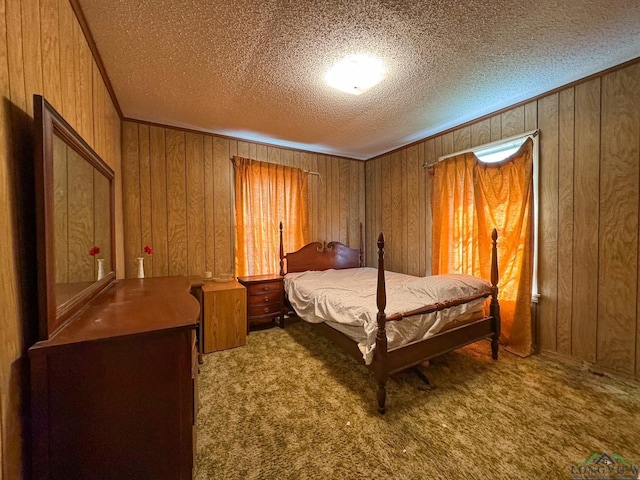 carpeted bedroom featuring ornamental molding, wooden walls, and a textured ceiling