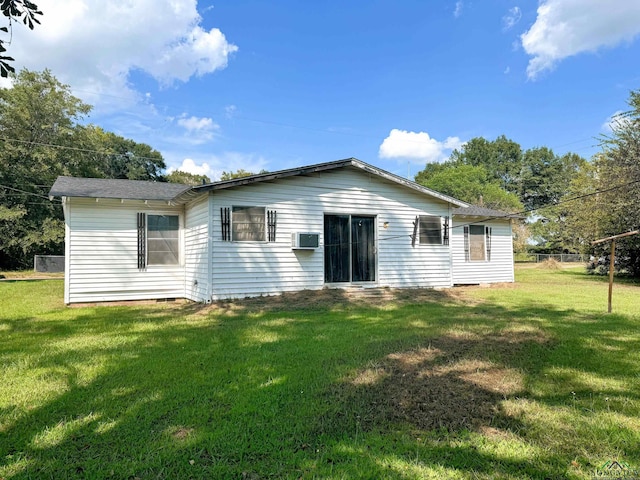 rear view of property featuring a yard