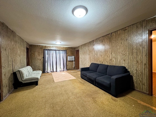 carpeted living room with wooden walls, a textured ceiling, and a wall unit AC