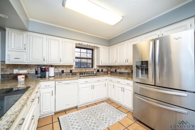 kitchen with sink, white dishwasher, light tile patterned flooring, stainless steel fridge with ice dispenser, and white cabinets