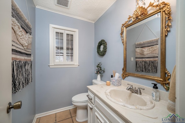 bathroom featuring a textured ceiling, tile patterned floors, vanity, toilet, and crown molding