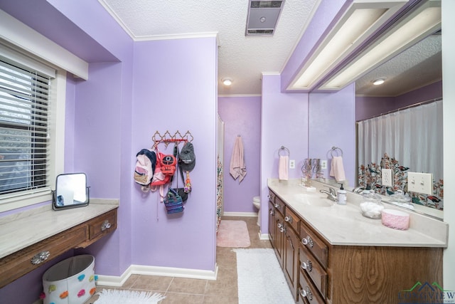 bathroom featuring a textured ceiling, tile patterned flooring, vanity, toilet, and crown molding