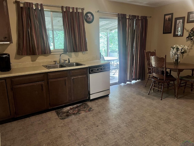 305 E Maple St, White Oak, TX 75693 - kitchen with white dishwasher, a sink, light countertops, and dark brown cabinetry