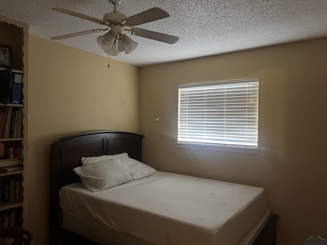 305 E Maple St, White Oak, TX 75693 - bedroom with a textured ceiling and a ceiling fan