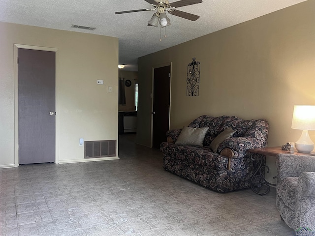 305 E Maple St, White Oak, TX 75693 - living area with a ceiling fan, a textured ceiling, and baseboards