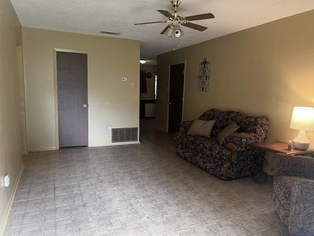 305 E Maple St, White Oak, TX 75693 - living room with ceiling fan, a textured ceiling, and baseboards