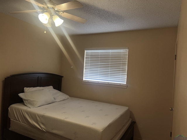 305 E Maple St, White Oak, TX 75693 - bedroom with a textured ceiling and ceiling fan