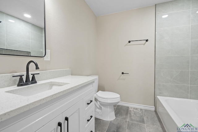 bathroom with toilet, baseboards, and vanity