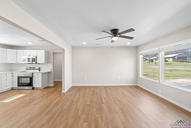 unfurnished living room featuring a ceiling fan, recessed lighting, baseboards, and light wood finished floors