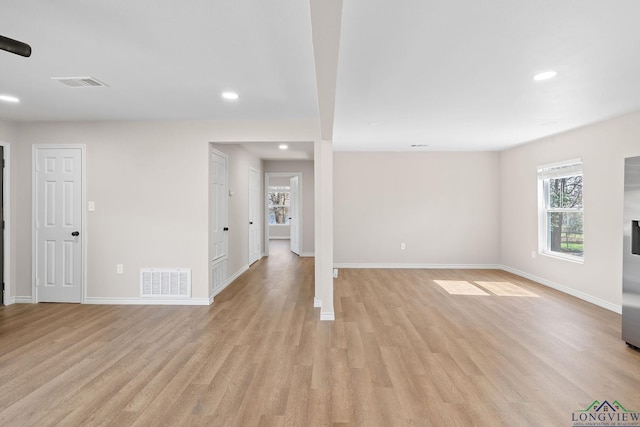 spare room featuring baseboards, recessed lighting, visible vents, and light wood-style floors