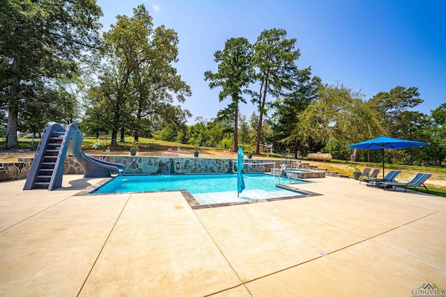 view of pool featuring a water slide, an in ground hot tub, and a patio