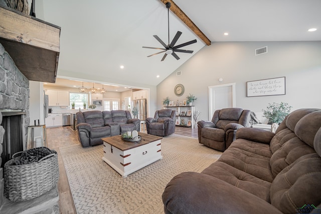 living room with high vaulted ceiling, ceiling fan, light hardwood / wood-style floors, a fireplace, and beam ceiling