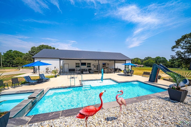 view of swimming pool featuring a patio area and a water slide