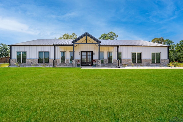 rear view of house with a yard and french doors