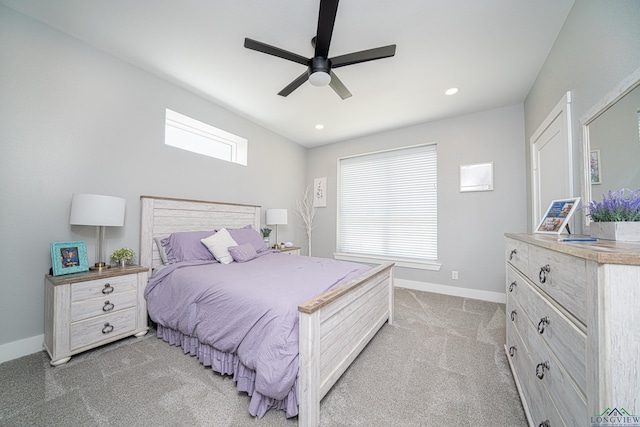 bedroom with multiple windows, light carpet, and ceiling fan