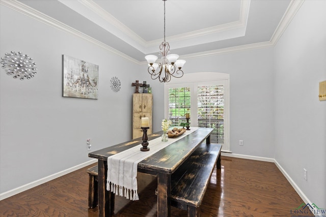 1312 Enchanted Ln, Longview, TX 75604 - dining room with a chandelier, dark wood-style flooring, a tray ceiling, ornamental molding, and baseboards