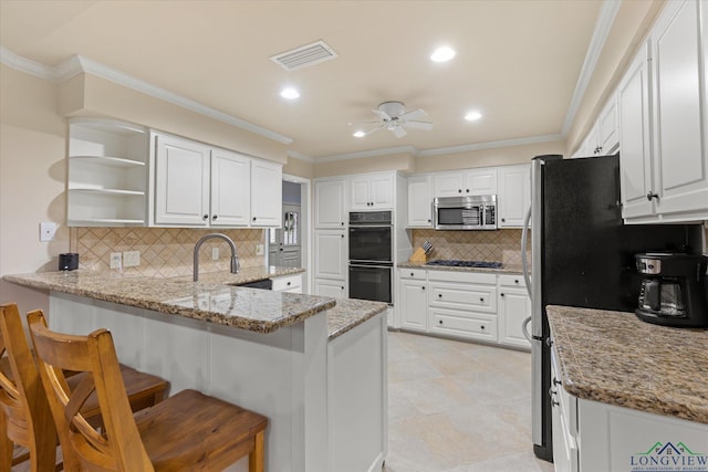 1312 Enchanted Ln, Longview, TX 75604 - kitchen featuring a peninsula, black appliances, open shelves, ceiling fan, and decorative backsplash