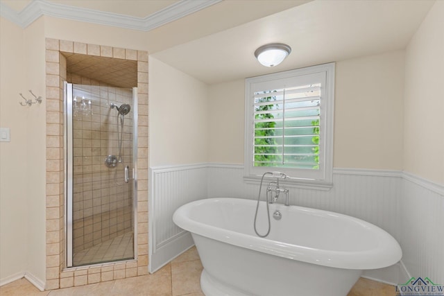 1312 Enchanted Ln, Longview, TX 75604 - bathroom with a shower stall, wainscoting, a freestanding tub, tile patterned floors, and crown molding