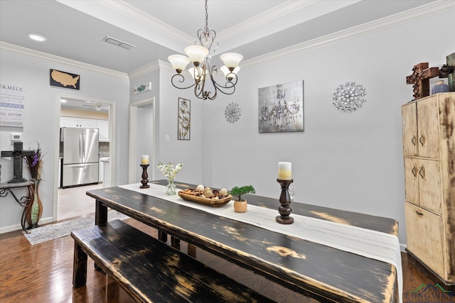1312 Enchanted Ln, Longview, TX 75604 - dining space featuring dark wood-type flooring, crown molding, baseboards, and a chandelier