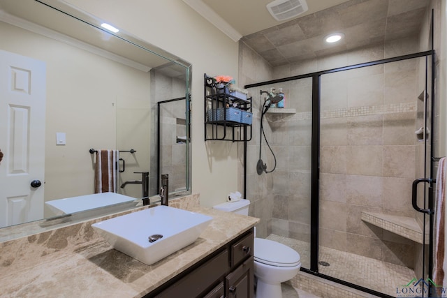 full bathroom with ornamental molding, visible vents, a stall shower, and vanity
