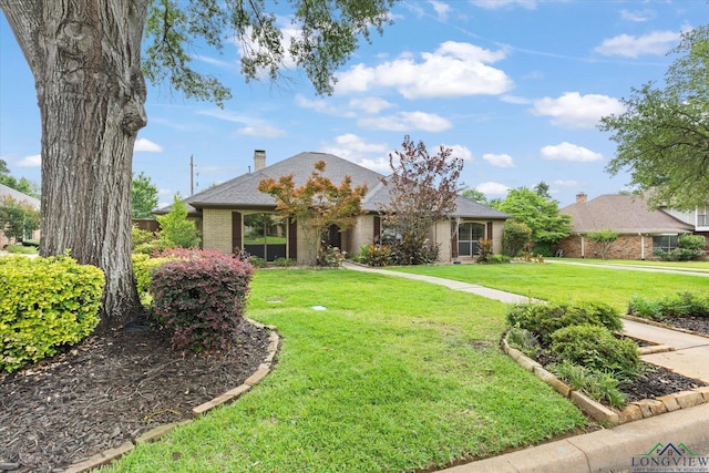 1312 Enchanted Ln, Longview, TX 75604 - view of front of house with a front yard, brick siding, and a chimney