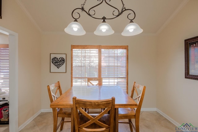 dining area with light tile patterned flooring, ornamental molding, and a healthy amount of sunlight