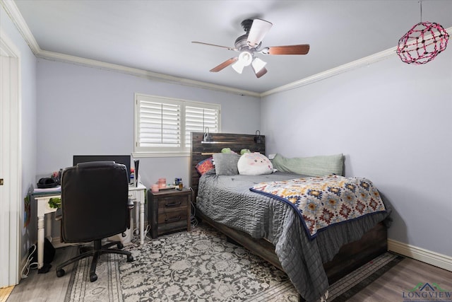 1312 Enchanted Ln, Longview, TX 75604 - bedroom featuring crown molding, wood finished floors, an office area, a ceiling fan, and baseboards