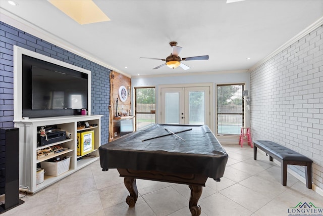 1312 Enchanted Ln, Longview, TX 75604 - game room with brick wall, crown molding, french doors, light tile patterned floors, and a ceiling fan