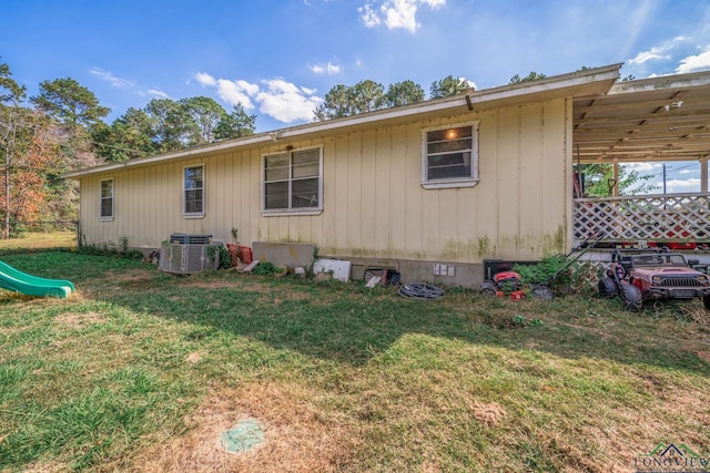 rear view of property with a yard