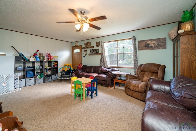 playroom with carpet flooring, ceiling fan, and a textured ceiling