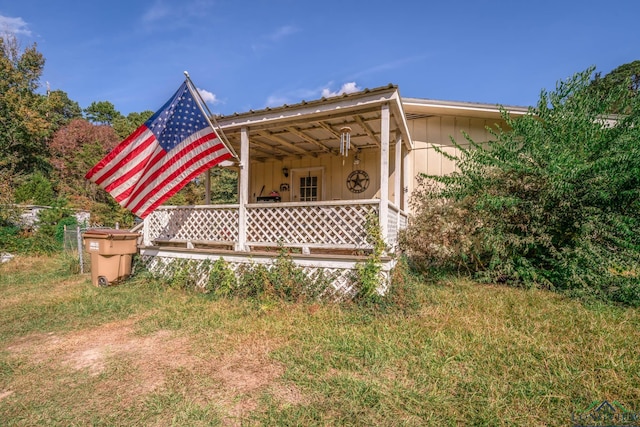 back of property with covered porch