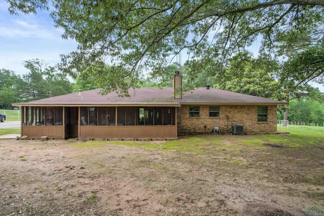 back of property featuring a sunroom and central AC