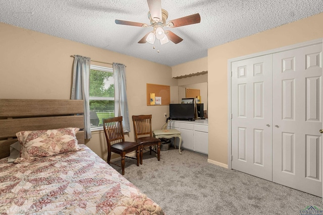 carpeted bedroom featuring a textured ceiling, a closet, and ceiling fan