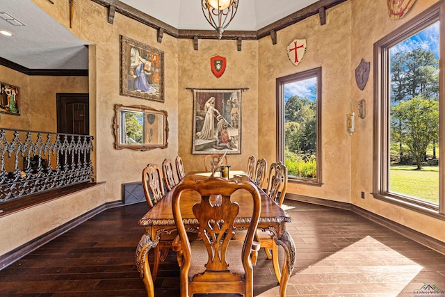 dining room featuring a chandelier, a wealth of natural light, dark wood-type flooring, and ornamental molding