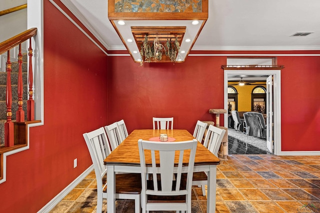 dining space with ornamental molding