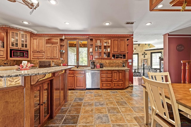 kitchen featuring sink, stainless steel dishwasher, a healthy amount of sunlight, and light stone counters