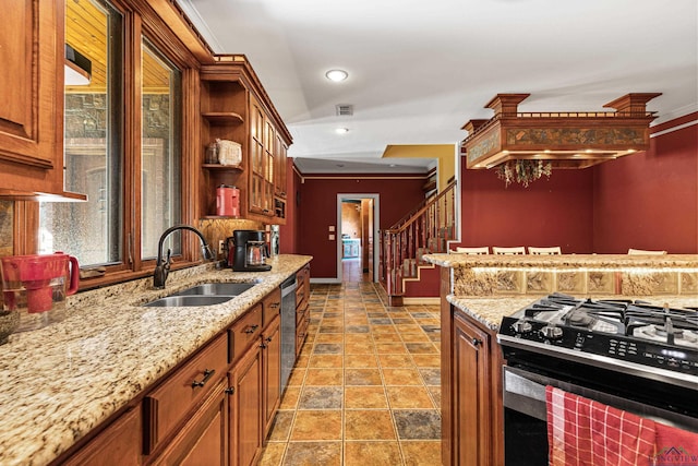 kitchen featuring light stone counters, sink, crown molding, and appliances with stainless steel finishes