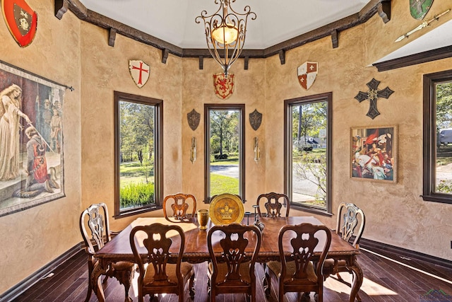 dining room featuring hardwood / wood-style flooring, ornamental molding, and a chandelier