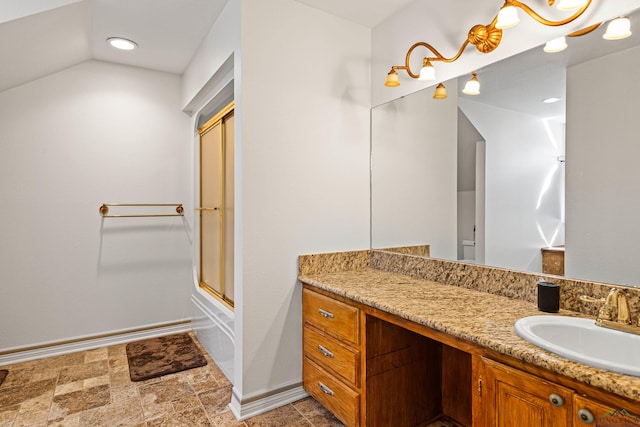 bathroom with combined bath / shower with glass door, vanity, and lofted ceiling