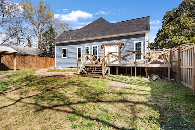 501 S Harrison St, Longview, TX 75601 - back of house featuring a fenced backyard, a wooden deck, and roof with shingles