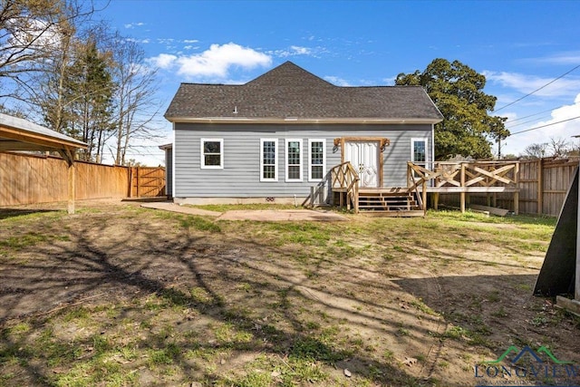 501 S Harrison St, Longview, TX 75601 - rear view of house featuring a wooden deck, a fenced backyard, and roof with shingles