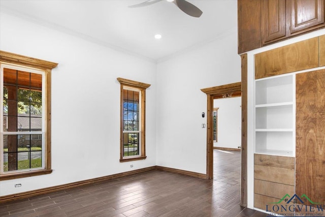 501 S Harrison St, Longview, TX 75601 - spare room featuring ceiling fan, dark wood-style flooring, ornamental molding, and baseboards