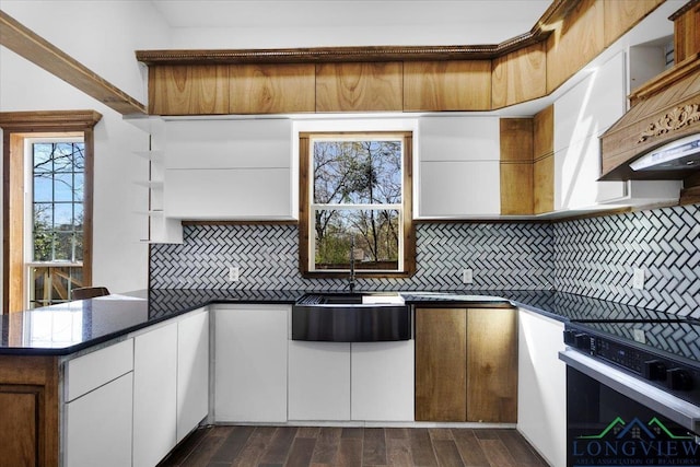 501 S Harrison St, Longview, TX 75601 - kitchen featuring a sink, stove, dark countertops, and tasteful backsplash