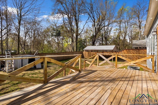 501 S Harrison St, Longview, TX 75601 - wooden terrace with a fenced backyard and view of scattered trees