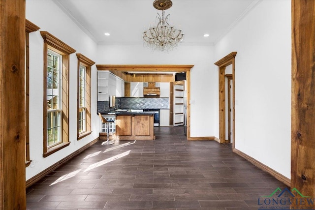 501 S Harrison St, Longview, TX 75601 - kitchen with dark countertops, plenty of natural light, ornamental molding, a chandelier, and a peninsula