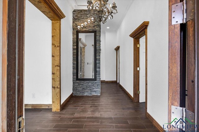 501 S Harrison St, Longview, TX 75601 - corridor featuring a chandelier, dark wood finished floors, and baseboards