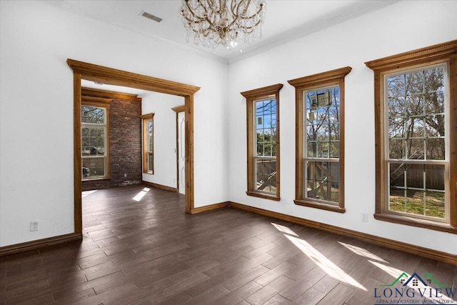 501 S Harrison St, Longview, TX 75601 - empty room with a chandelier, dark wood finished floors, baseboards, and ornamental molding